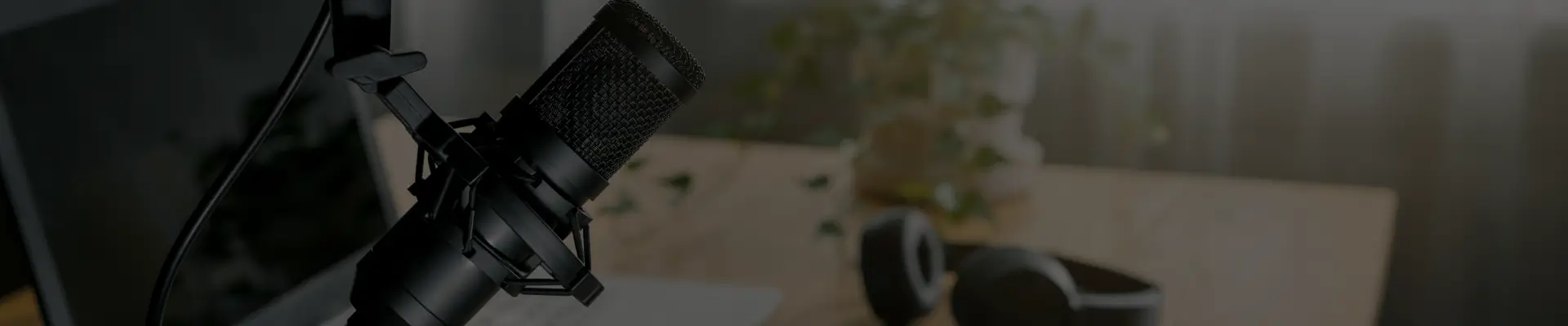 Podcasting setup: microphone and headphones on desk